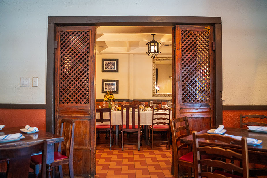 The Original Room at Ninfa's on Navigation with wooden doors, set tables, and warm lighting.